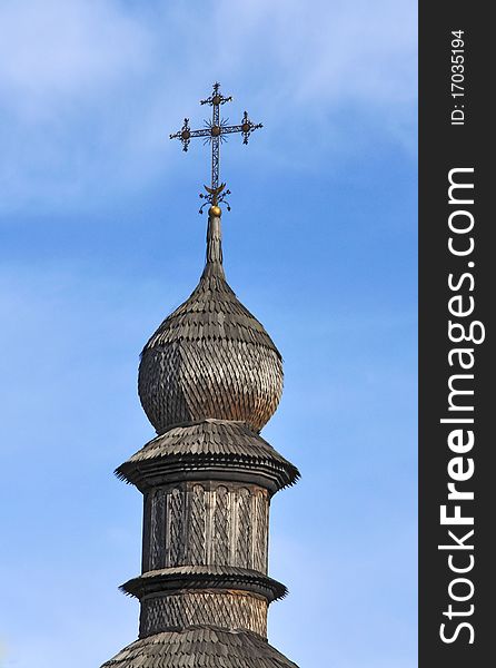 Dome of wooden church against the blue sky