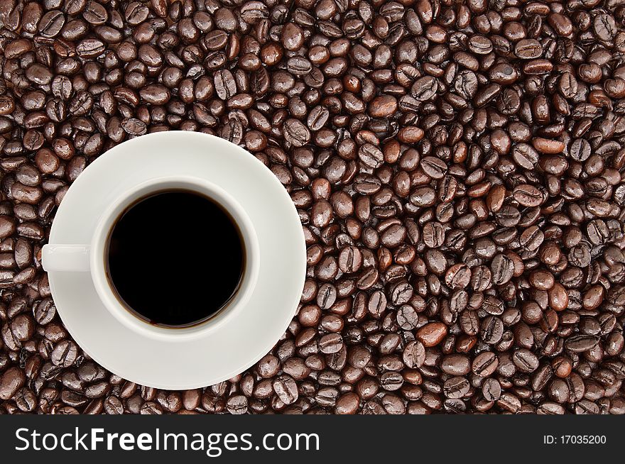 Coffee cup on coffee bean background,top view