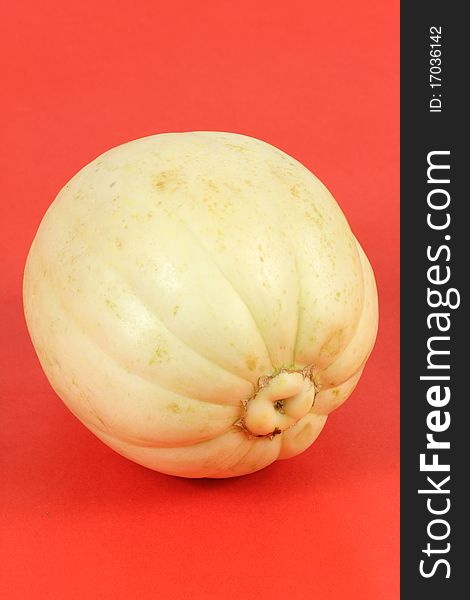 Melon isolated on red background