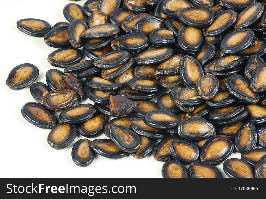 Black melon seeds on white