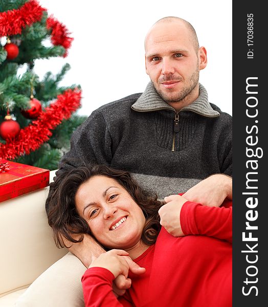 Young happy couple near a Christmas tree. Young happy couple near a Christmas tree