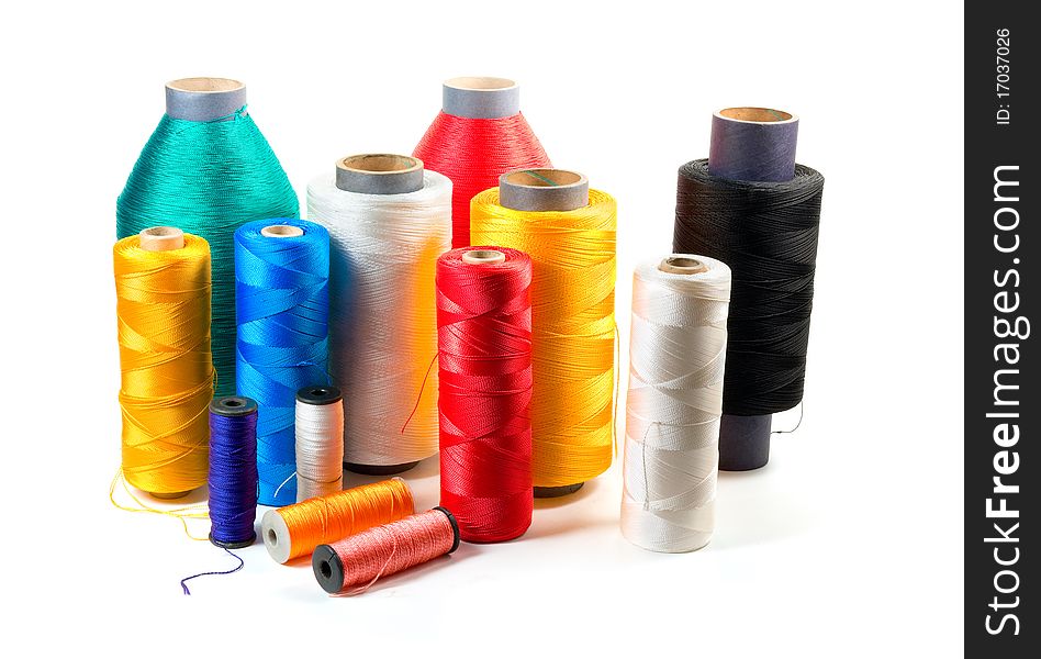 Set of color bobbins on a white background