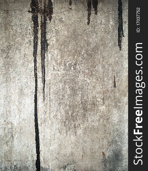 Texture of dirty black color drop on grunge old wall vertical