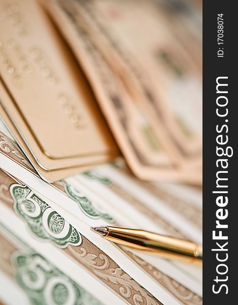 Golden pen, money and bank card. closeup. shallow depth of field. Golden pen, money and bank card. closeup. shallow depth of field.