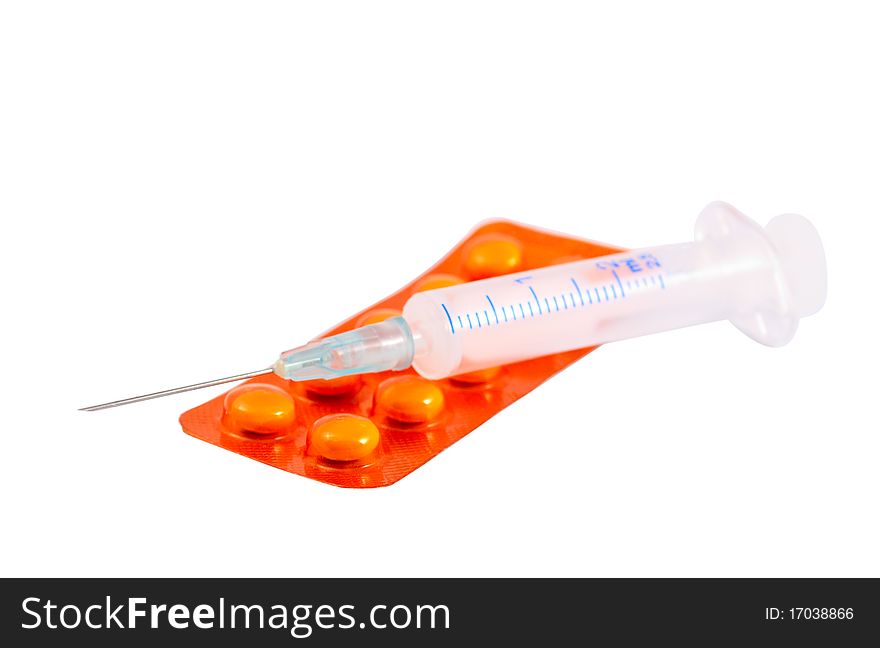 Syringe and pills on a white background
