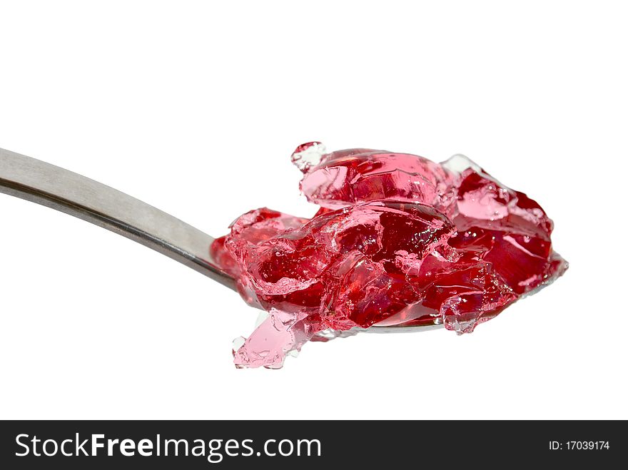Metal spoon with pink jelly isolated on white background