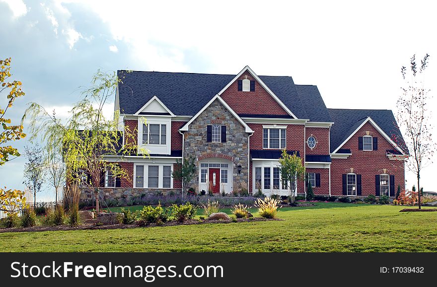 Stone faced mansion with elaborate landscaping. Stone faced mansion with elaborate landscaping.