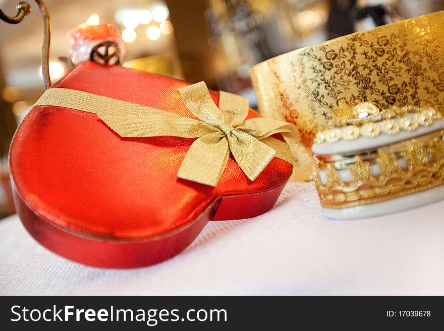 Red box with golden ribbon and bow. Red box with golden ribbon and bow.