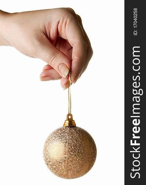 Female hand holding gold cristmas bauble isolated on white. Female hand holding gold cristmas bauble isolated on white