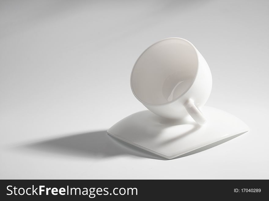 An empty coffee cup on a gray background with shadow