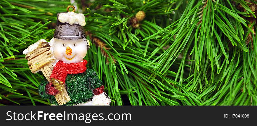 Cute snowman with sitting under a pine tree. Cute snowman with sitting under a pine tree