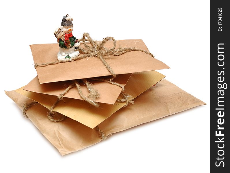 Brown shipping parcel tied with twine and snowman. Brown shipping parcel tied with twine and snowman