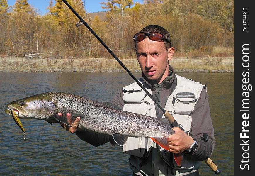 Fishing on river - fisherman catched big fish