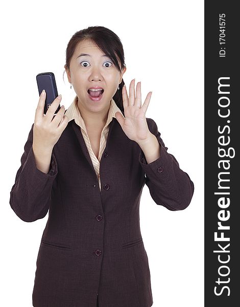 An Asian businesswoman looking shocked and holding a cellphone. An Asian businesswoman looking shocked and holding a cellphone