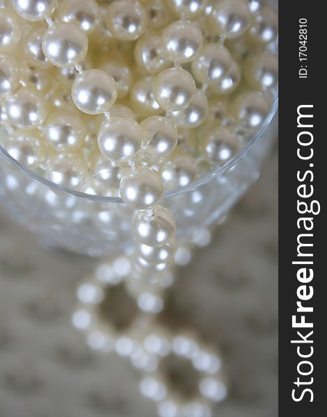 Strings of pearls in a crystal glass