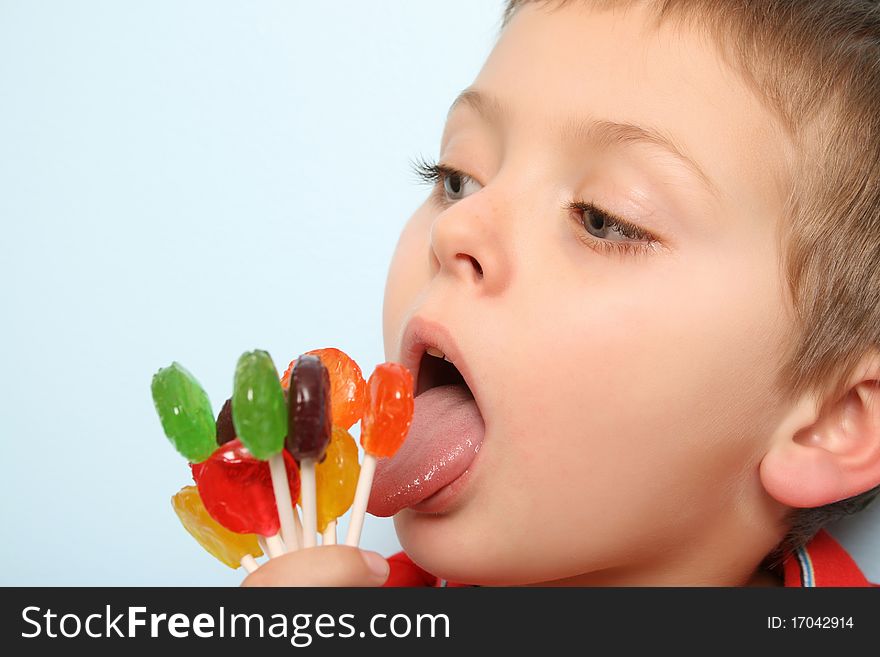 Beautiful blond boy with hand full of lollies. Beautiful blond boy with hand full of lollies