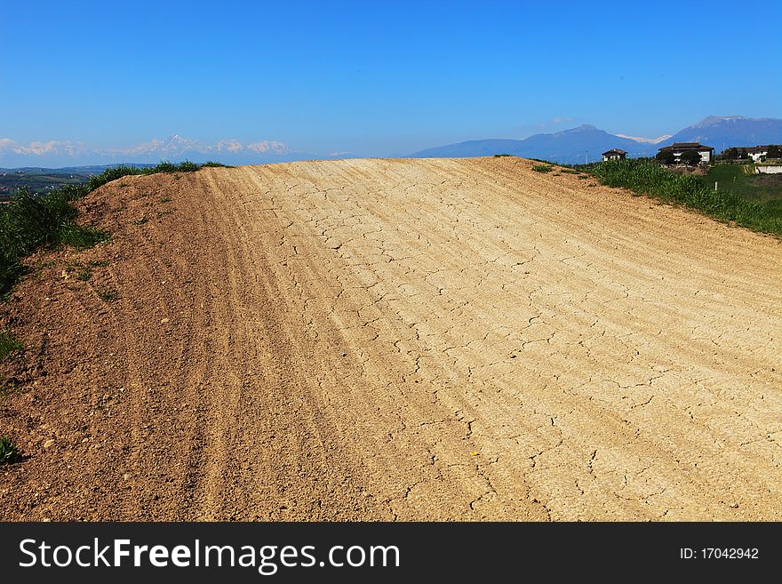 Dusty and rutted dirt road. Focus on tire ruts.