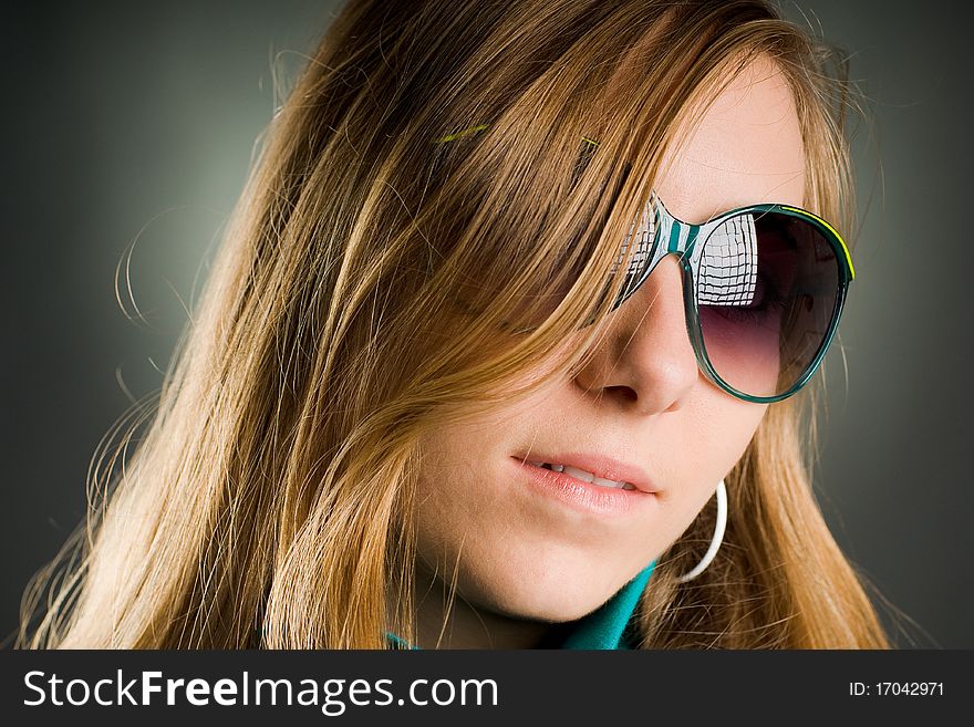 Beautiful portrait of a woman with big sunglasses in the studio. Beautiful portrait of a woman with big sunglasses in the studio