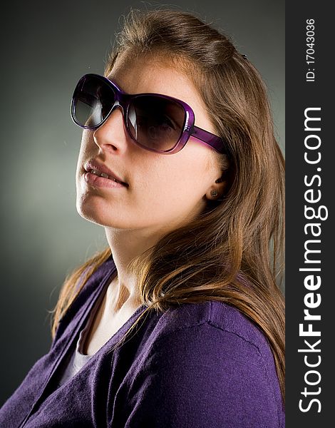 Beautiful portrait of a woman with big sunglasses in the studio. Beautiful portrait of a woman with big sunglasses in the studio