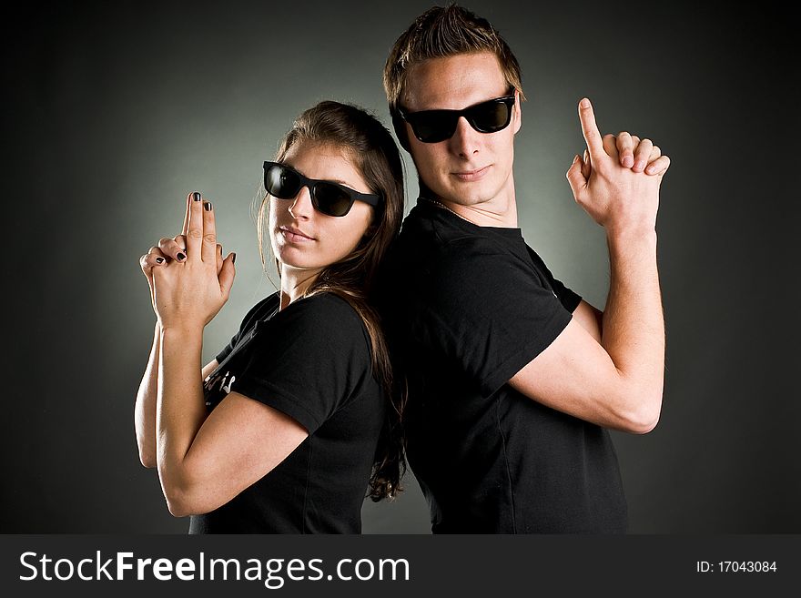 Wild couple with sunglasses and finger guns. Wild couple with sunglasses and finger guns