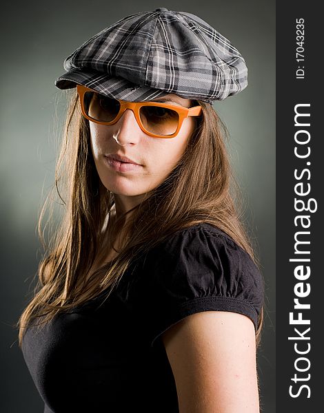 Sexy portrait of a woman with orange sunglasses and cap. Sexy portrait of a woman with orange sunglasses and cap