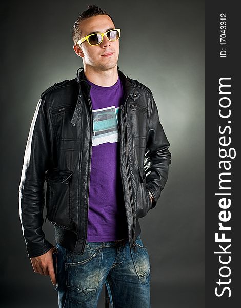 Attractive man with yellow sunglasses and leather jacket