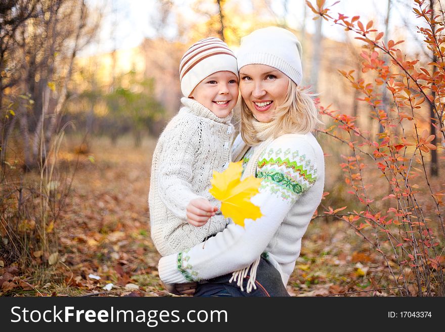 Happy young mother and her son spending time outdoor in the park. Happy young mother and her son spending time outdoor in the park