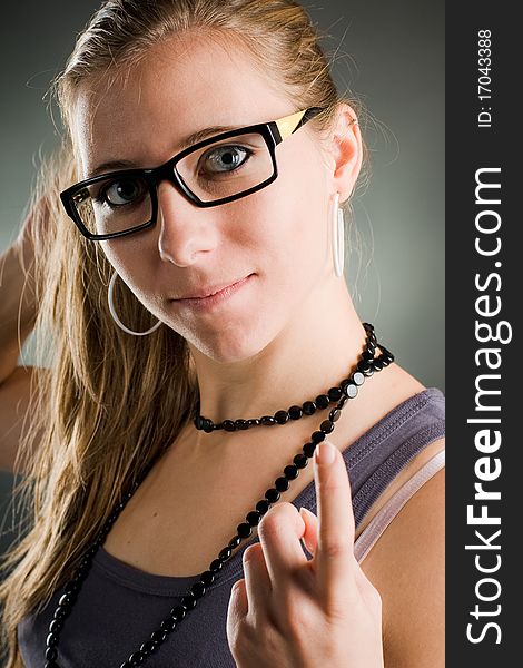 Portrait of a woman with glasses saying come closer. Portrait of a woman with glasses saying come closer