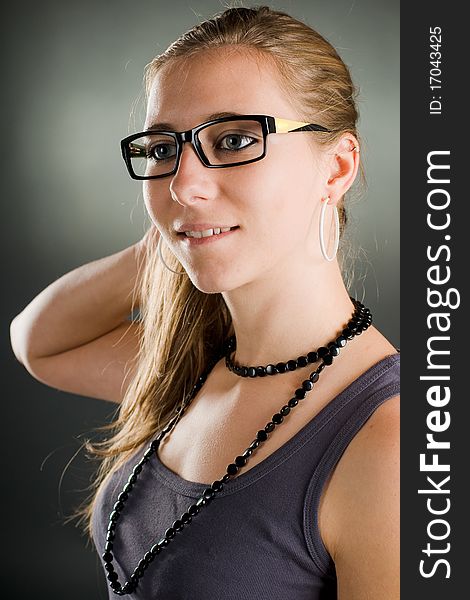 Beautiful portrait of a woman with glasses in the studio