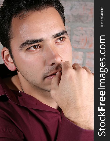 Male model against a rough brick wall background