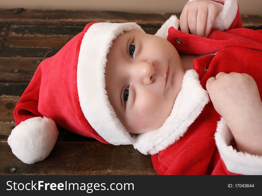 Beautiful six week old baby boy wearing a Christmas suit. Beautiful six week old baby boy wearing a Christmas suit