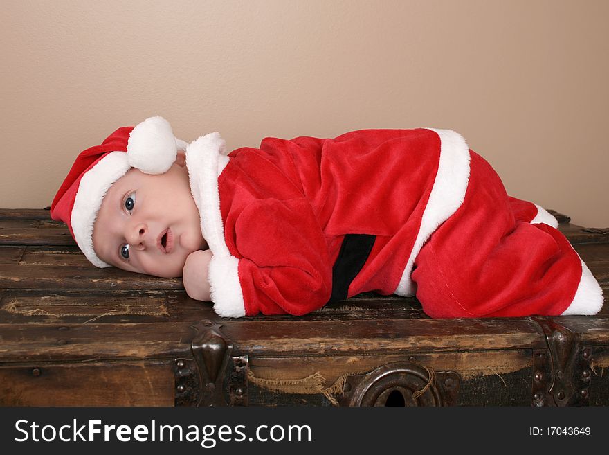 Beautiful six week old baby boy wearing a Christmas suit. Beautiful six week old baby boy wearing a Christmas suit