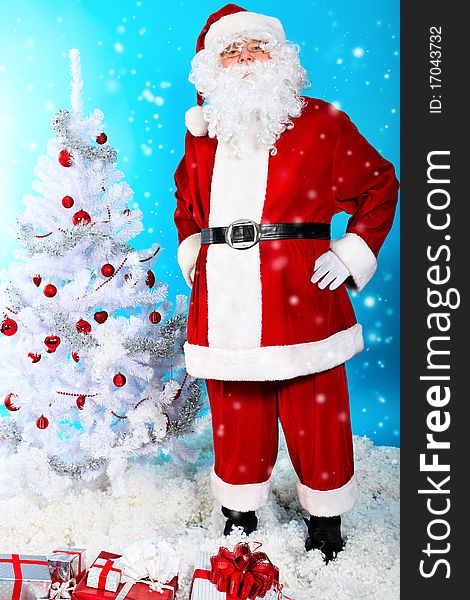 Christmas theme: Santa Claus with presents and christmas tree, over blue background. Christmas theme: Santa Claus with presents and christmas tree, over blue background.