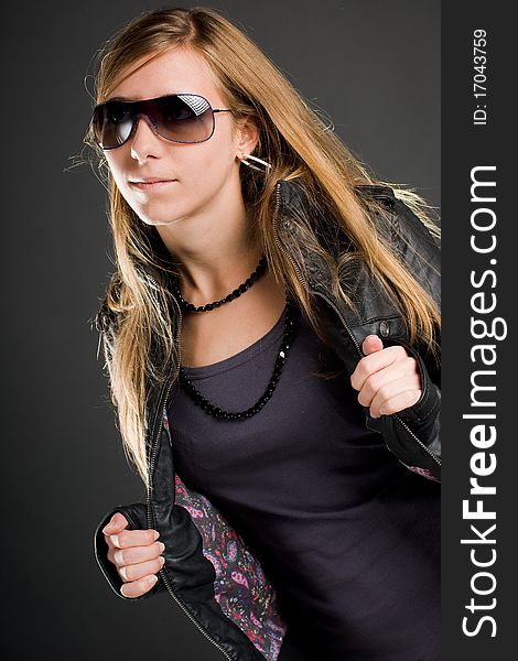 woman with sunglasses and open leather jacket. woman with sunglasses and open leather jacket