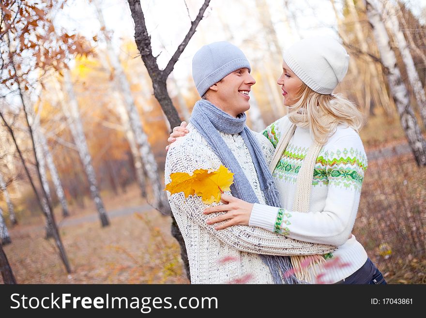 Happy young couple spending time outdoor in the park. Happy young couple spending time outdoor in the park