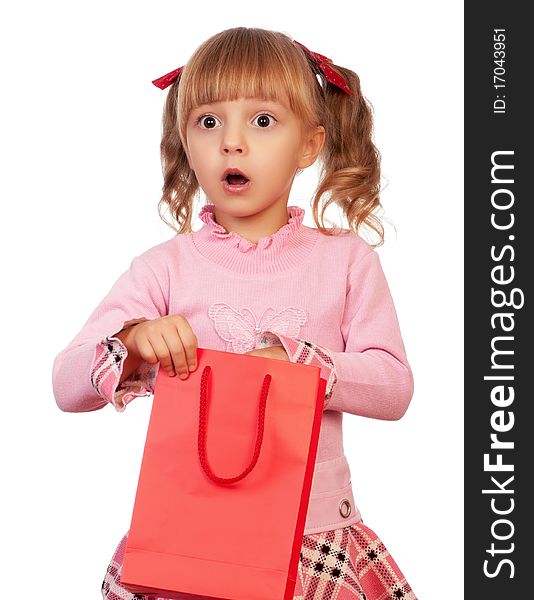 Surprised christmas girl holding shopping bag. Isolated on white background.