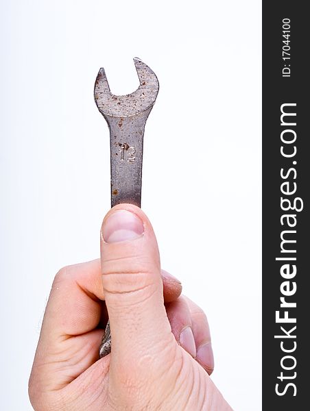 Mans hand holding a metallic tool. Mans hand holding a metallic tool