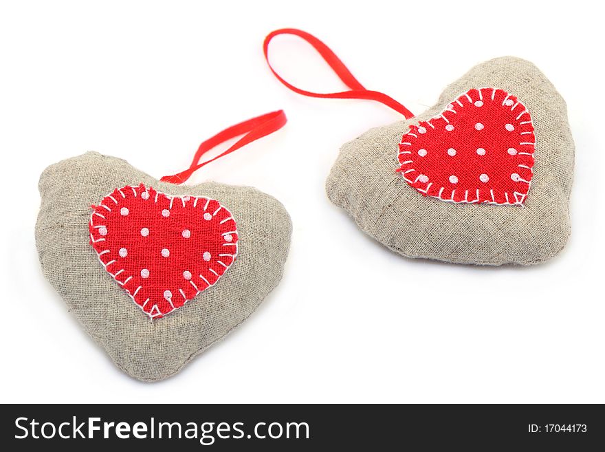 New Year's toys hearts sewed from a gray and red fabric. New Year's toys hearts sewed from a gray and red fabric