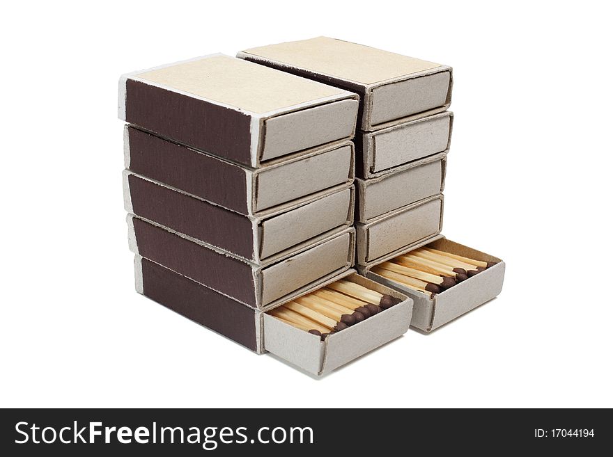 Pile of cardboard matchboxes with matches on a white background