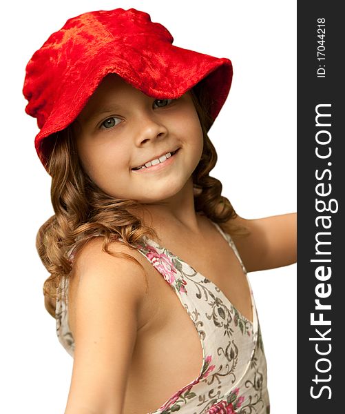 The little smiling girl in a red hat. Isolated on a white.