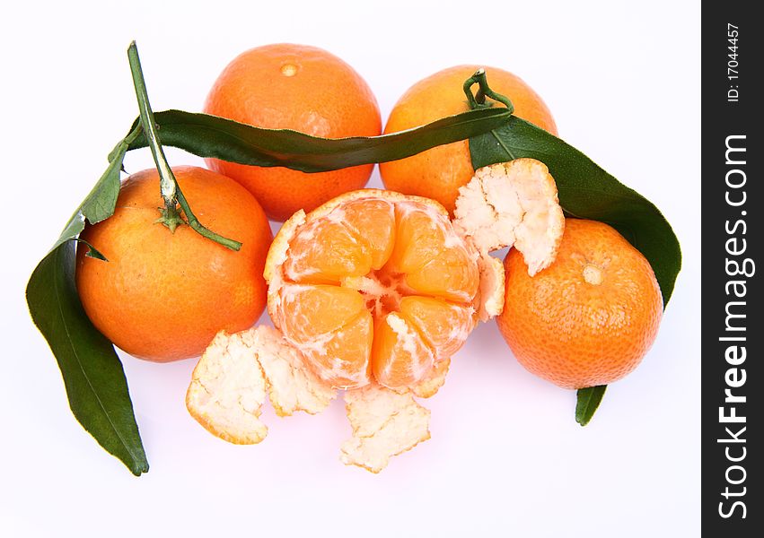 Mandarin oranges one partially peeled, on white background