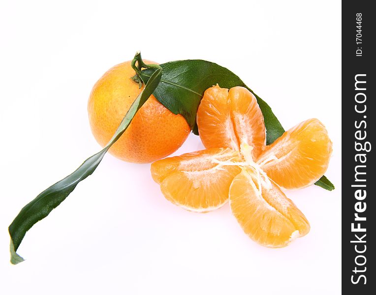 Mandarin with leaves and sections on white background. Mandarin with leaves and sections on white background