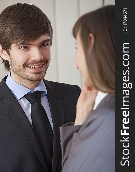 Business conversation - man and woman in suits talking together