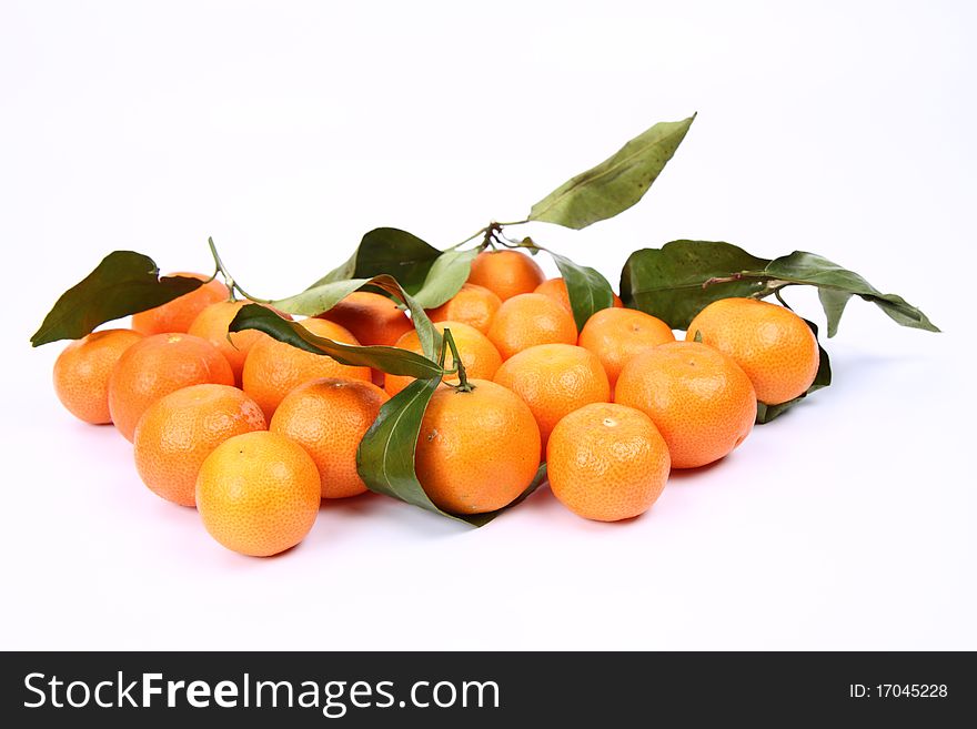 Mandarins, some with leaves, on white background. Mandarins, some with leaves, on white background