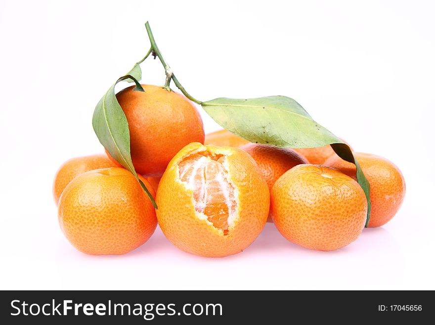 Mandarin oranges one partially peeled, on white background