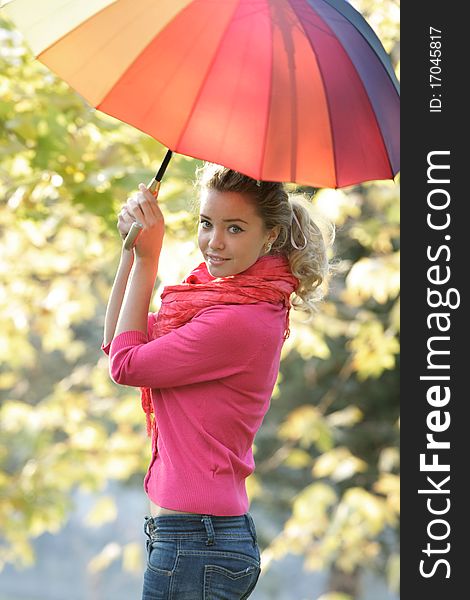 Attractive girl with colorful umbrella on natural background