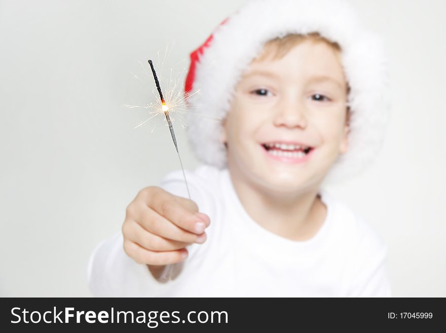 Santa boy with sparkler over white