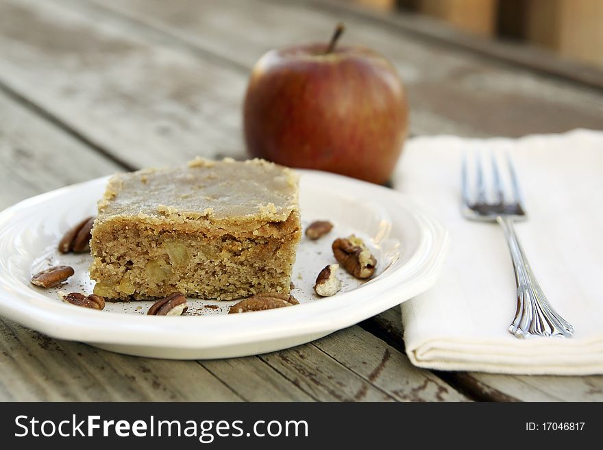 Slice of apple cake with brown sugar glaze.