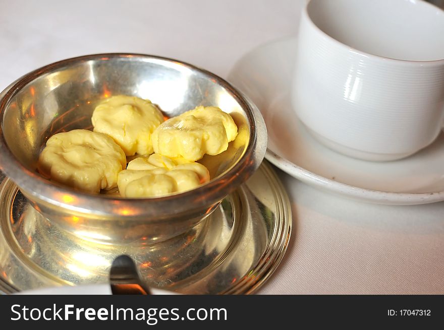 Butter pieces in container for breakfast or an afternoon tea snack.