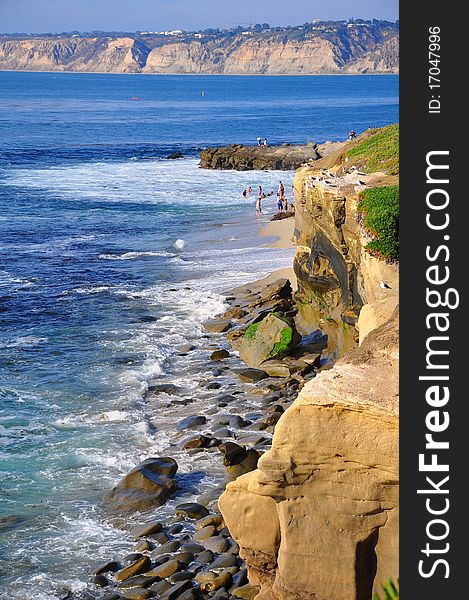 Rocky coastline with bluffs in the distance